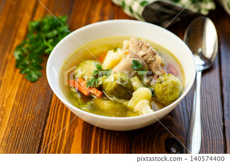 warm homemade vegetable soup with chicken and potatoes 140574400