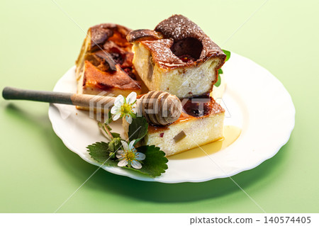 Creamy cottage cheese bake with honey and strawberry garnish Creamy cottage cheese bake with honey and strawberry garnish 140574405