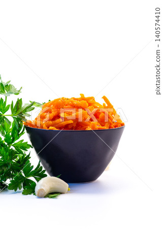 Spicy shredded carrot salad in black bowl on white background 140574410