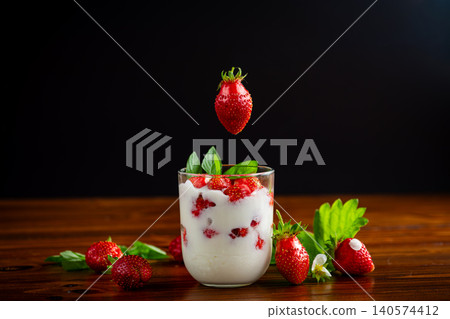 Delicious summer dessert with berries and green leaves Delicious summer dessert with berries and green leaves 140574412