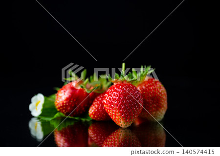 Fresh ripe strawberries with reflection on black background Fresh ripe strawberries with reflection on black background 140574415