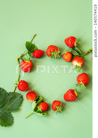 Top view of fresh strawberries and green foliage 140574419