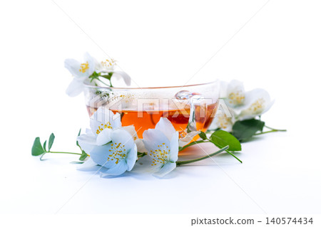 jasmine tea with white jasmine flowers on white background jasmine tea with white jasmine flowers on white background 140574434