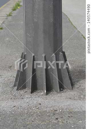 Metal Pole Base with Reinforcement Gussets on Sidewalk Metal Pole Base with Reinforcement Gussets on Sidewalk 140574490
