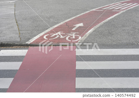 Red Bicycle Lane Crossing and Pedestrian Zebra Marking on Asphalt Red Bicycle Lane Crossing and Pedestrian Zebra Marking on Asphalt 140574492