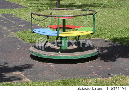 Colorful Playground Carousel Merry Go Round in Public Park Colorful Playground Carousel Merry Go Round in Public Park 140574494