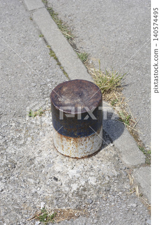 Old Rusty Blue and White Metal Bollard on Asphalt Sidewalk Old Rusty Blue and White Metal Bollard on Asphalt Sidewalk 140574495