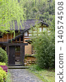 A house with a dark tiled roof among bamboo and trees in the mountains near Zhangjiajie, China 140574508