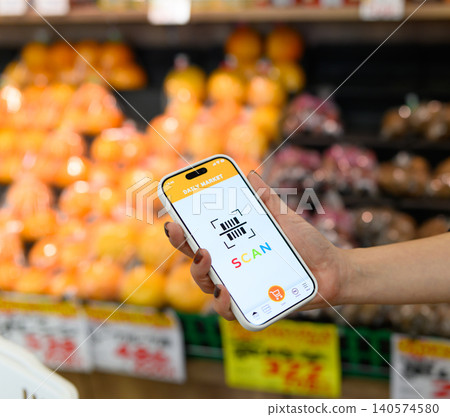 Shoppers scanning with their smartphones 140574580