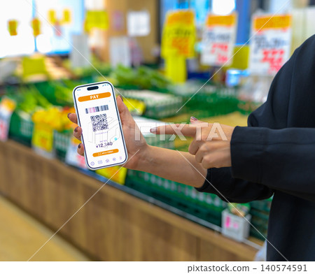 A woman's hand pointing to a smartphone payment screen. A woman's hand pointing to a smartphone payment screen. 140574591