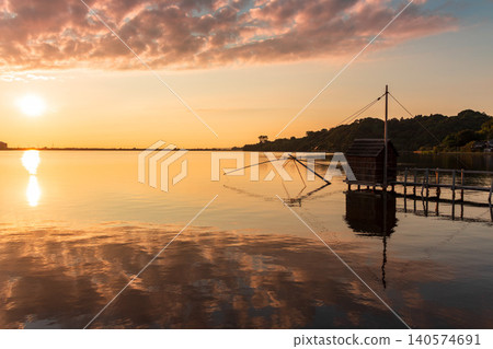 The tranquil evening view of Lake Togo, bathed in the colors of the setting sun. 140574691