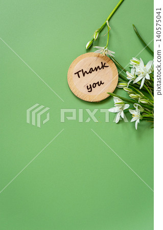 Minimal spring greeting card with floral bouquet and green backdrop 140575041