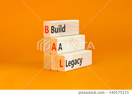 BAL build a legacy symbol. Concept words BAL build a legacy on beautiful wooden blocks. Beautiful orange background. Business BAL build a legacy concept. Copy space 140575215