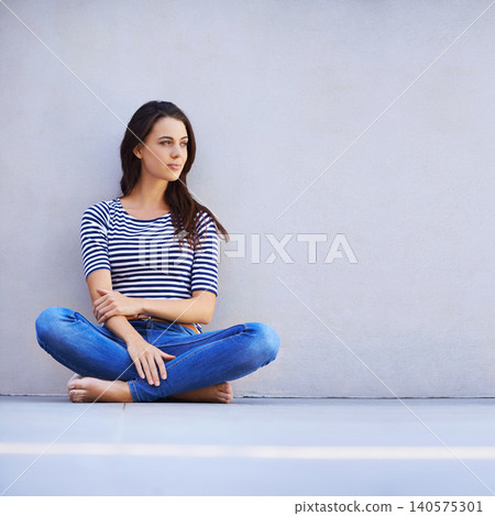 Thinking, woman and style on floor for leisure with casual outfit for fashion or comfort, relax and wellness with smile. Female person, isolated with grey background or wall for clothing with mockup. Thinking, woman and style on floor for leisure with casual outfit for fashion or comfort, relax and wellness with smile. Female person, isolated with grey background or wall for clothing with mockup. 140575301