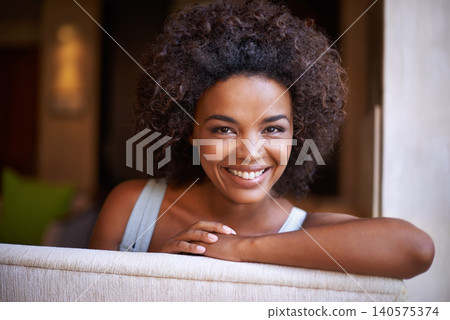 Smile, sofa and portrait of woman in living room for weekend rest, break or afternoon free time. Relax, happy and face of black female person on couch with positive mood, satisfaction and enjoyment Smile, sofa and portrait of woman in living room for weekend rest, break or afternoon free time. Relax, happy and face of black female person on couch with positive mood, satisfaction and enjoyment 140575374