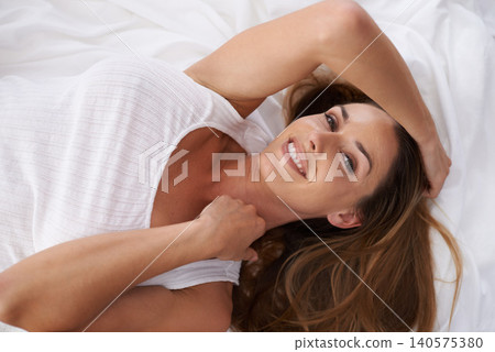Portrait, top view and happy woman in bed in home to relax or wake up in the morning in apartment in Spain. Face, above and smile of person in bedroom, resting and comfortable on sheets in house Portrait, top view and happy woman in bed in home to relax or wake up in the morning in apartment in Spain. Face, above and smile of person in bedroom, resting and comfortable on sheets in house 140575380