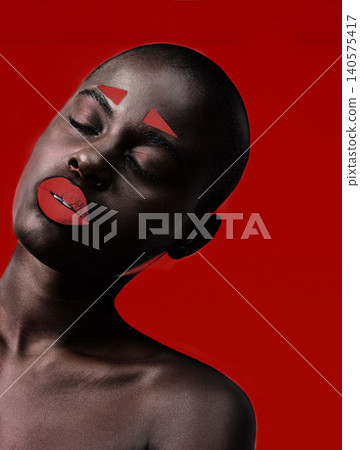 Black woman, makeup and artistic with red, skin and creative with studio and color. Model, closeup and face paint for cosmetics, contrast and aesthetic for glamour isolated on background for beauty 140575417