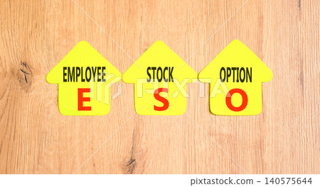 ESO employee stock option symbol. Concept words ESO employee stock option on beautiful yellow paper houses. Beautiful wooden background. Business ESO employee stock option concept. Copy space. ESO employee stock option symbol. Concept words ESO employee stock option on beautiful yellow paper houses. Beautiful wooden background. Business ESO employee stock option concept. Copy space. 140575644