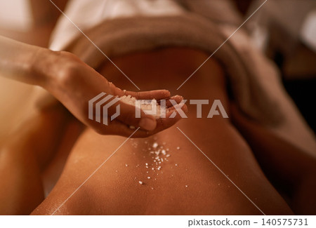 Hand, back and salt at spa for massage, skin care and wellness for luxury, holistic therapy and peace. Grain, exfoliate and health for lifestyle, body and person on table, calm and natural Hand, back and salt at spa for massage, skin care and wellness for luxury, holistic therapy and peace. Grain, exfoliate and health for lifestyle, body and person on table, calm and natural 140575731