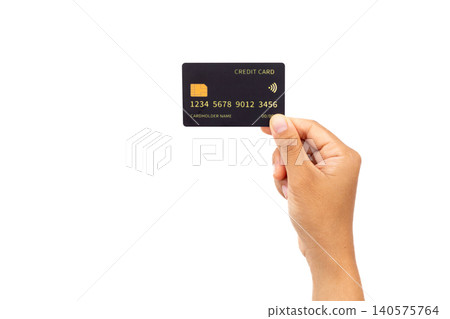 Hand holds credit card against plain white background. Simple composition draws focus to card details. Card shows generic numbers and chip symbol clearly. Hand presents card with gentle Hand holds credit card against plain white background. Simple composition draws focus to card details. Card shows generic numbers and chip symbol clearly. Hand presents card with gentle 140575764