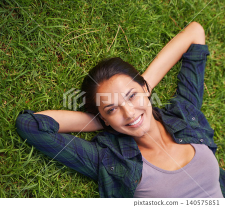Relax, nature and portrait of woman on grass for peace, satisfaction and good mood in outdoor park. Summer, green lawn and face of woman with happiness for rest, wellness and carefree enjoyment Relax, nature and portrait of woman on grass for peace, satisfaction and good mood in outdoor park. Summer, green lawn and face of woman with happiness for rest, wellness and carefree enjoyment 140575851