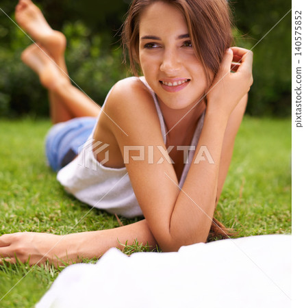 Woman, thinking or happiness on grass for relax with sunshine, enjoyment or weekend break in summer. Young person, smile or thoughtful on lawn, garden or backyard of home for fresh air in environment Woman, thinking or happiness on grass for relax with sunshine, enjoyment or weekend break in summer. Young person, smile or thoughtful on lawn, garden or backyard of home for fresh air in environment 140575852
