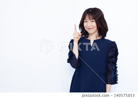 A working woman holding up her index finger A working woman holding up her index finger 140575853