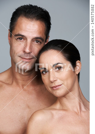 Mature couple, portrait and skincare in studio, beauty and collagen cosmetics for anti aging. People, facial treatment and dermatology for health on gray background, love and together for wellness Mature couple, portrait and skincare in studio, beauty and collagen cosmetics for anti aging. People, facial treatment and dermatology for health on gray background, love and together for wellness 140575882
