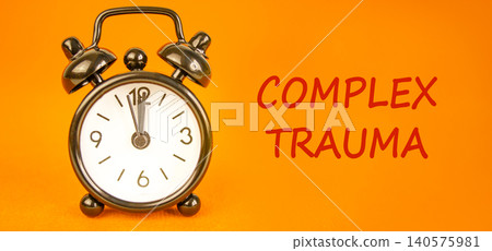 Complex trauma words symbol. Concept words Complex trauma on beautiful white paper. Beautiful orange background. Black alarm clock. Psychological complex trauma support concept. Copy space. Complex trauma words symbol. Concept words Complex trauma on beautiful white paper. Beautiful orange background. Black alarm clock. Psychological complex trauma support concept. Copy space. 140575981