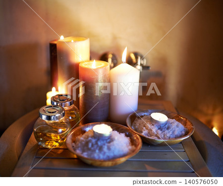 Spa, candle and oil with salt in room for peace or luxury with aromatherapy to relax, zen and meditation. Aromatic or cosmetic liquid, table and candlelight for mindfulness or wellness and self care. Spa, candle and oil with salt in room for peace or luxury with aromatherapy to relax, zen and meditation. Aromatic or cosmetic liquid, table and candlelight for mindfulness or wellness and self care. 140576050
