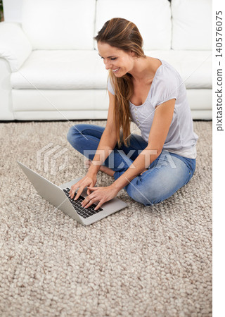 Woman, smile and laptop on floor with reading for blogging, communication and email on mat in living room of home. Person, happy and technology on ground with relax, networking and writing project Woman, smile and laptop on floor with reading for blogging, communication and email on mat in living room of home. Person, happy and technology on ground with relax, networking and writing project 140576075