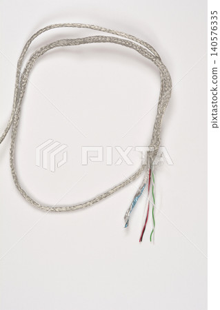 Shielded multicore cable with exposed wires isolated on white Shielded multicore cable with exposed wires isolated on white 140576335