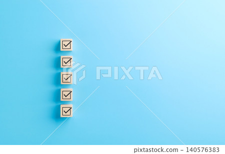 Checklist concept. Correct sign tick checkmark on wooden block with copy space for the checklist on light blue background. Business survey questionnaire, Exam test process, filling digital form online Checklist concept. Correct sign tick checkmark on wooden block with copy space for the checklist on light blue background. Business survey questionnaire, Exam test process, filling digital form online 140576383
