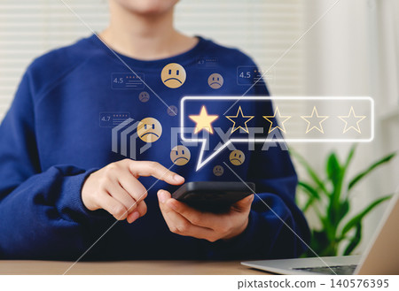 Negative customer review, online feedback concept. Woman using smartphone to leave one star review, with sad face emojis and rating icons. customer feedback, online reviews, consumer dissatisfaction, Negative customer review, online feedback concept. Woman using smartphone to leave one star review, with sad face emojis and rating icons. customer feedback, online reviews, consumer dissatisfaction, 140576395