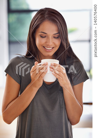 Woman, coffee and mug with kitchen, smile and morning for home routine. Person, cup and tea with house, beverage and aroma for relax and caffeine or taste cheerful to enjoy break with happiness Woman, coffee and mug with kitchen, smile and morning for home routine. Person, cup and tea with house, beverage and aroma for relax and caffeine or taste cheerful to enjoy break with happiness 140576400