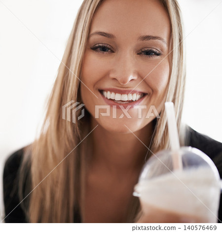 Portrait, happy woman and drinking a smoothie in home, wellness and wellness for break on weekend. Face, positive and healthy person with fruit cocktail on sofa, nutrition and vitamins in apartment 140576469
