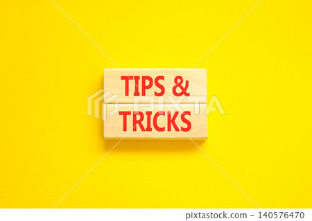 Tips and tricks words symbol. Concept words Tips and tricks on beautiful wooden blocks. Beautiful yellow background. Business tips and tricks motivational support concept. Copy space. Tips and tricks words symbol. Concept words Tips and tricks on beautiful wooden blocks. Beautiful yellow background. Business tips and tricks motivational support concept. Copy space. 140576470