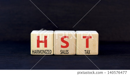 HST harmonized sales tax symbol. Concept words HST harmonized sales tax on beautiful wooden blocks. Beautiful black background. Business HST harmonized sales tax concept. Copy space HST harmonized sales tax symbol. Concept words HST harmonized sales tax on beautiful wooden blocks. Beautiful black background. Business HST harmonized sales tax concept. Copy space 140576477