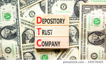 DTC depository trust company symbol. Concept words DTC depository trust company on beautiful wooden blocks. Beautiful dollar bills background. Business DTC depository trust company concept. Copy space 140576485