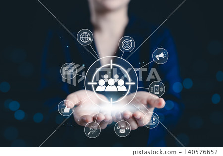 Digital marketing and target audience concept. Business professional holding digital interface with icons representing audience targeting, advertising, SEO, social media, online marketing strategies, 140576652