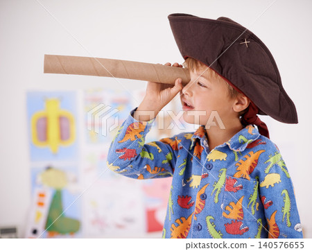 House, telescope or costume as pirate to play in fantasy in his bedroom with vision toy or creativity. Kid sailor, child captain or young boy in a game with pyjamas, hat or monocular to sail on bed House, telescope or costume as pirate to play in fantasy in his bedroom with vision toy or creativity. Kid sailor, child captain or young boy in a game with pyjamas, hat or monocular to sail on bed 140576655