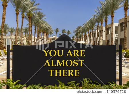 You are almost there symbol. Concept words You are almost there on beautiful black road sign. Beautiful blue sky background. Business You are almost there motivational support concept. Copy space You are almost there symbol. Concept words You are almost there on beautiful black road sign. Beautiful blue sky background. Business You are almost there motivational support concept. Copy space 140576728