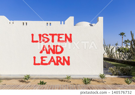 Listen and learn words symbol. Concept words Listen and learn on beautiful white wall. Beautiful blue sky background. Business listen and learn support concept. Copy space. Listen and learn words symbol. Concept words Listen and learn on beautiful white wall. Beautiful blue sky background. Business listen and learn support concept. Copy space. 140576732
