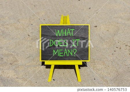 What does it mean words symbol. Concept words What does it mean on beautiful black blackboard. Beautiful sand beach background. Business What does it mean motivational support concept. Copy space. What does it mean words symbol. Concept words What does it mean on beautiful black blackboard. Beautiful sand beach background. Business What does it mean motivational support concept. Copy space. 140576753