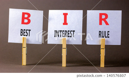 BIR best interest rule symbol. Concept words BIR best interest rule on beautiful white papers on wooden clothespins. Beautiful grey background. Business BIR best interest rule concept. Copy space. BIR best interest rule symbol. Concept words BIR best interest rule on beautiful white papers on wooden clothespins. Beautiful grey background. Business BIR best interest rule concept. Copy space. 140576807