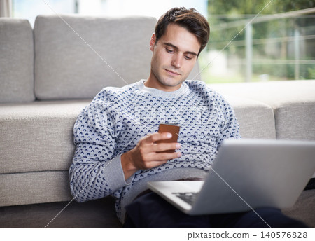 Man, phone and relax with sofa in living room for tech, social media and research in home or indoor on weekend. Male person or freelancer and looking on screen for browse with internet and online Man, phone and relax with sofa in living room for tech, social media and research in home or indoor on weekend. Male person or freelancer and looking on screen for browse with internet and online 140576828