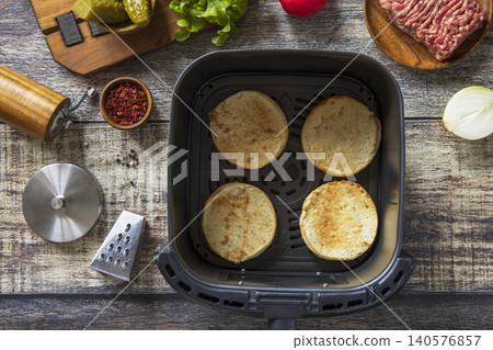 Step 2. Cooking homemade cheeseburger in kitchen gadget modern air fryer. Lifestyle trendy of new cooking. Step 2. Cooking homemade cheeseburger in kitchen gadget modern air fryer. Lifestyle trendy of new cooking. 140576857