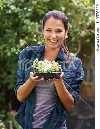 Woman, smile and seedling for gardening and plant in environment outdoor with tree and sunshine. Gardener and happy person with shrub in soil for sustainability, growth and earth for lawn or garden Woman, smile and seedling for gardening and plant in environment outdoor with tree and sunshine. Gardener and happy person with shrub in soil for sustainability, growth and earth for lawn or garden 140576899