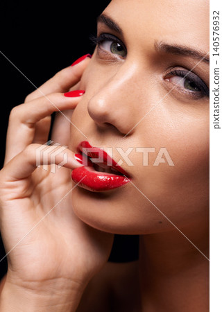 Makeup, manicure and portrait of woman in studio with trendy, beauty and face routine with red lips. Cosmetics, nail polish and female model with facial cosmetology treatment by black background. Makeup, manicure and portrait of woman in studio with trendy, beauty and face routine with red lips. Cosmetics, nail polish and female model with facial cosmetology treatment by black background. 140576932