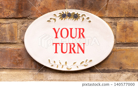 Your turn words symbol. Concept words Your turn on beautiful white sign plate. Beautiful brown brick wall background. Business your turn motivational support concept. Copy space. 140577000